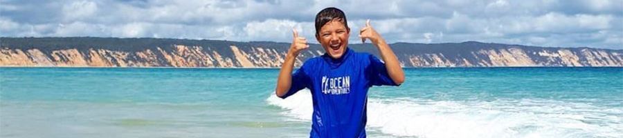 guy smiling while surfing at a lesson in rainbow beach