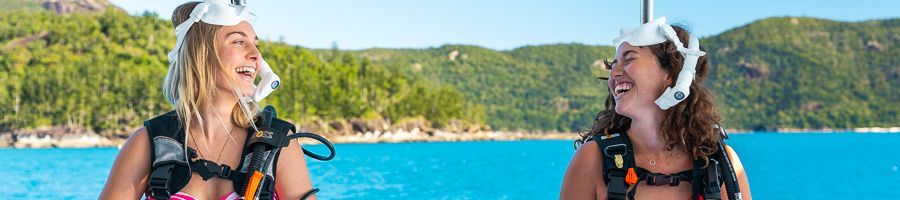 two backpacker smiling with snorkel and dive gear