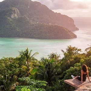 A backpacker at the top of a lookout point on Phi Phi Island