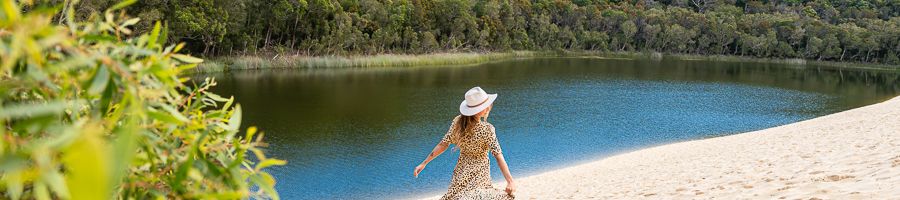 traveller walking past lake wabby on kgari sand dunes