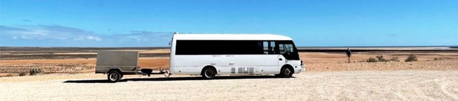 coach bus parked on a remote road in western australia