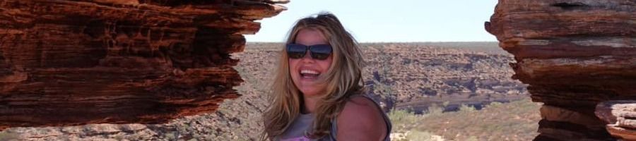 girl smiling at a rocky lookout in kalbarri national park