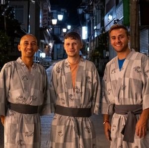 Two backpackers and a monk at a Buddhist temple in Japan