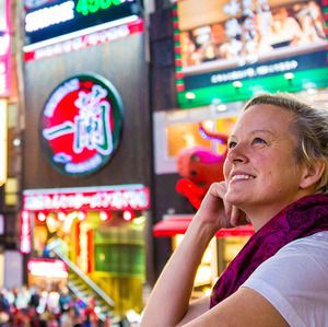 A woman admiring the neon lights in Osaka, Japan