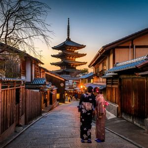 People walking through Kyoto, Japan in the evening