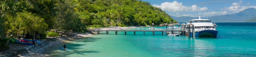 fitzroy island ferry next to the jetty over blue water