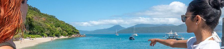 girls pointing at the beach on fitzroy island cairns