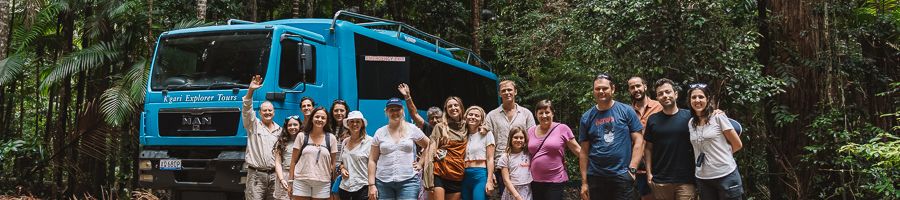 group of travellers in front of kgari explorer bus