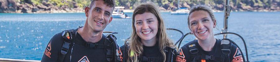 three divers on a boat in the whitsundays