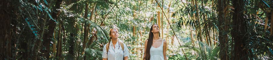 girls walking through the forest on an island