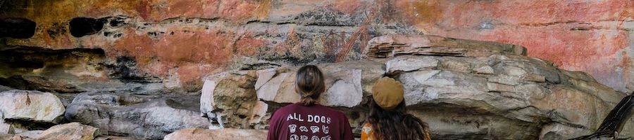 couple admiring the rock art in a cliff kakadu national park