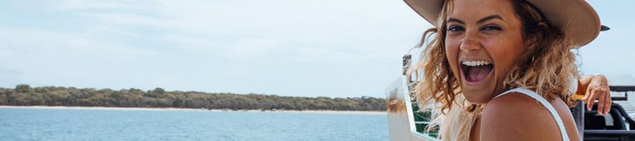 girl smiling on the ferry over to kgari