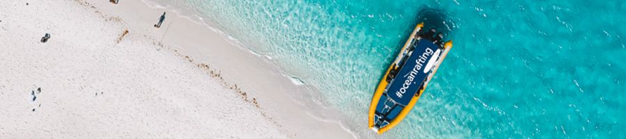 ocean rafting boat on the edge of whitehaven beach