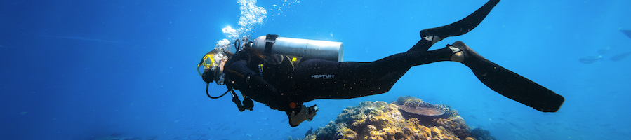 A woman underwater scuba diving 