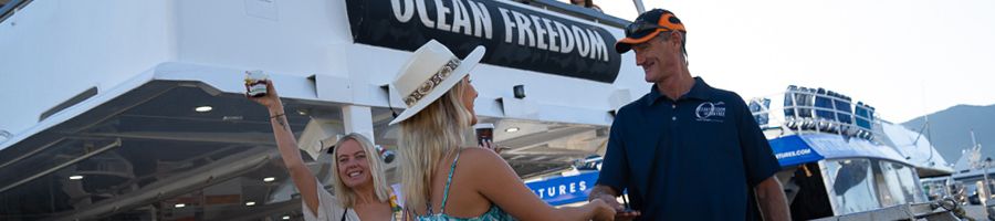 girls meeting ocean freedom captain near the boat