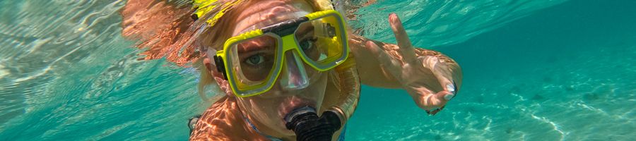 girl snorkelling underwater taking a selfie